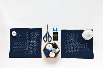 Japanese-style Sashiko embroidery is white thread embroidery on blue cotton fabric with basting...
