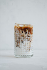 A glass of coffee latte at white background