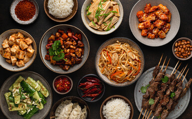 chinese food, chinese traditional cuisine dishes on dark background, top view, copy space