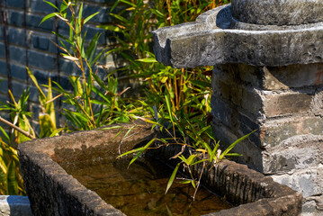 Stone mill running water pool in Chinese classical garden