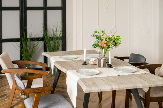 modern dinning room with modern chair and vase of plant on table