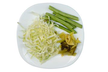Vegetables on a white plate together with white cabbage,Pickled Cabbage and Lentils. on isolated white background.