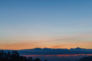 Heaven at early morning with copy space. Sunset, sunrise backdrop.Predawn clear sky with orange horizon and blue atmosphere. Smooth orange blue gradient of dawn sky.