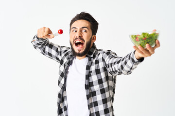 emotional bearded man in plaid shirt plate with salad