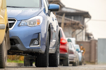 Cars parked in a row on a city street side