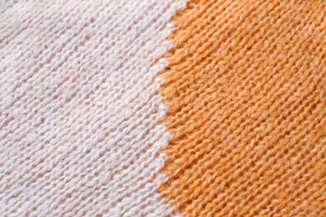 White and yellow woolen natural texture, knitted textile background, close-up