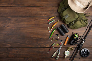 Fishing tackle - fishing spinning rod, hooks and lures on wooden background. Active hobby recreation concept. - 469309025