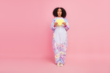 Full size photo of young african girl wondered look empty space plump lips feelings heart isolated over pink color background