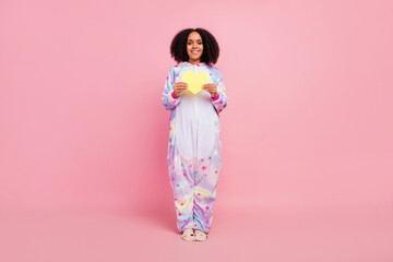 Full body photo of youth pretty african lady affection wear overall cupid isolated over pink color background