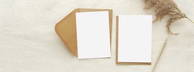 Two blank letter paper sheets or greeting cards mockup with brown envelopes for design presentation, banner for online shop cover with notecards mock up.