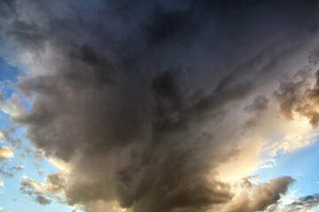 Landscape of dark clouds forming on stormy sky during thunderstorm