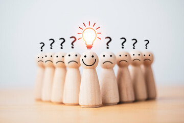 Smiley wooden human with light bulb and others human with question mark for creative thinking and...