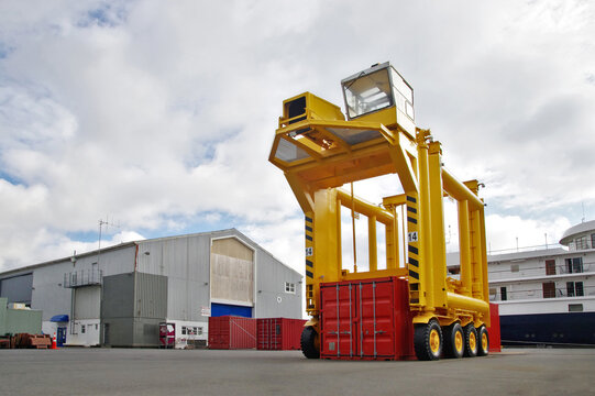 Yellow machine for handling the shipping containers. Container handler in the port.