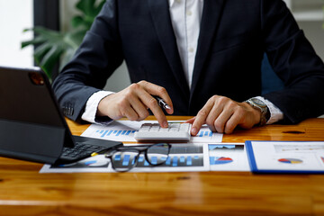 Businessman working at office with documents on his desk, doing planning analyzing the financial...
