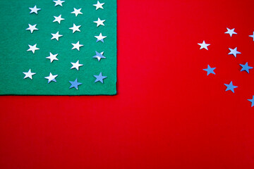 Christmas stars on a green background with red and white stripes in the form of an American flag.