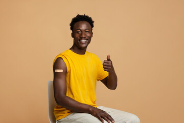 Vaccination Concept. Happy Vaccinated Black Guy Showing Thumb Up At Camera