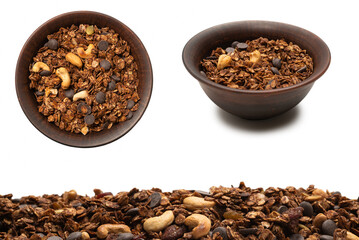 Chocolate granola cereal with nuts in a bowl background.
