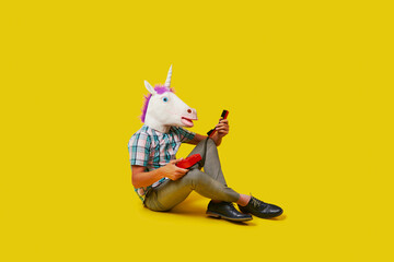 unicorn man is on the phone sitting on the floor © nito