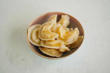 Russian dumplings with potato on white table