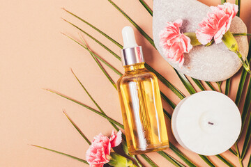 Obraz na płótnie Canvas Natural skincare oil bottle next to fresh flowers
