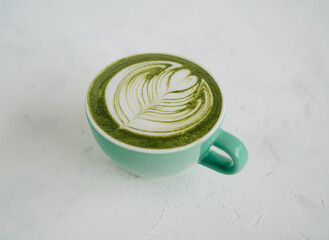 A cup of hot matcha on white background
