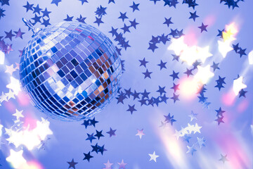 Fototapeta na wymiar Shiny disco ball with rays on neon blue background. Creative party background with copy space. Happy New Year.
