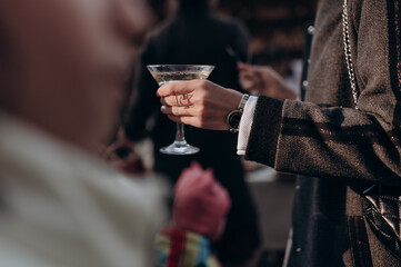 the girl holds the sides with champagne in her hand