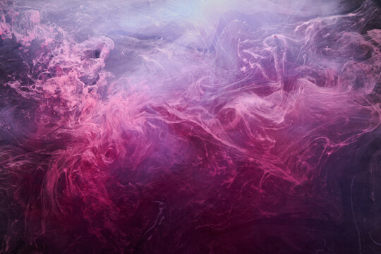 Pink smoke on black ink background, colorful fog, abstract swirling touch ocean sea, acrylic paint pigment underwater