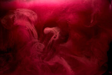 Pink smoke on black ink background, colorful fog, abstract swirling touch ocean sea, acrylic paint pigment underwater © amixstudio