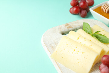 Concept of cooking eating with hard cheese on mint background