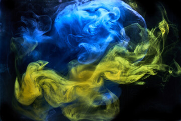 Obraz premium Blue yellow smoke on black ink background, colorful fog, abstract swirling ocean sea, acrylic paint pigment underwater
