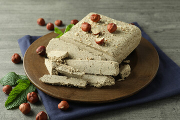 Concept of tasty food with halva on gray wooden background