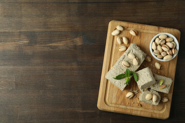 Concept of tasty food with halva on wooden background