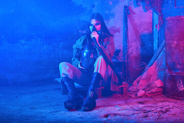 Obraz premium girl with respirator in neon light in an abandoned building. concept