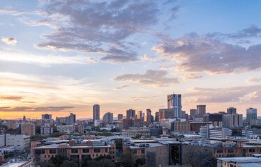 Aerial shot of Pretoria city skylines during a colourful sunset - obrazy, fototapety, plakaty