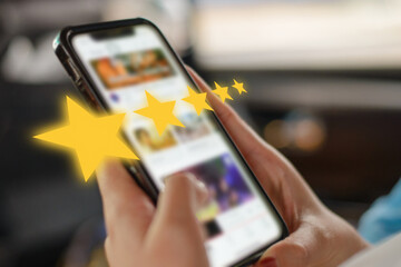 Woman customer hand holding on screen and pressing with gold five star rating feedback icon for service business concept.