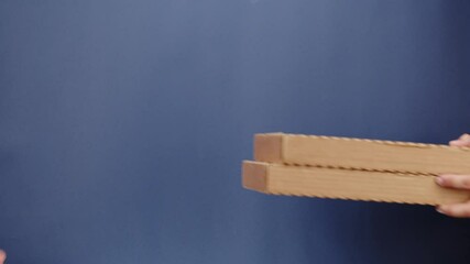 Square cardboard boxes on blue background. Preparing take away meals. Online contactless food shopping. Food delivery service. Courier taking order, delivering to customer. 