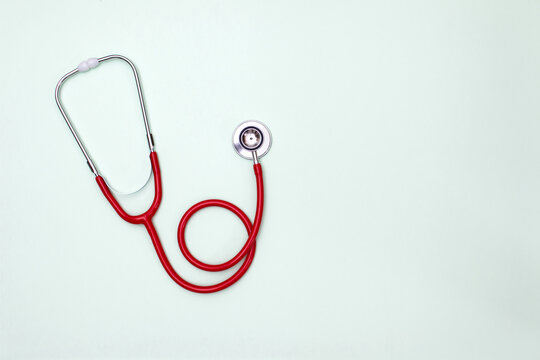 Stethoscope on green background top view. Medical tool