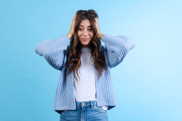 Portrait of young emotional girl posing isolated on navy color studio background in neon light....