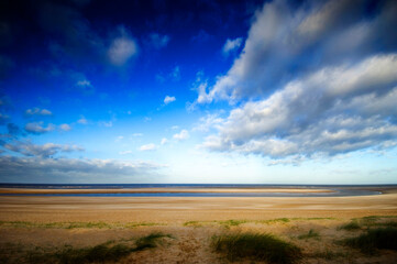 Fototapeta na wymiar Vast empty beach of Burnham Overy Staithe, North Norfolk Coast, England, UK.