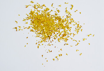Group of golden shiny confetti on a white background