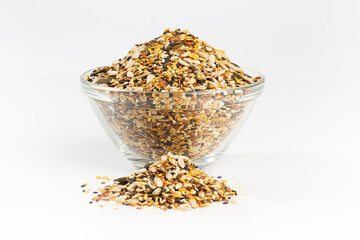 Raw seeds mix in a glass bowl isolated on white background.