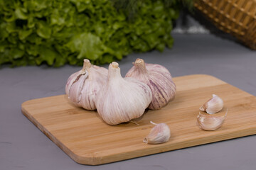 Garlic cloves on the wooden desk and gray background