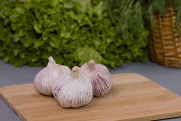 Garlic cloves on the wooden desk and gray background
