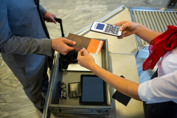Man showing documents and smartphone with covid 19 vaccine passport at chek in