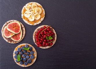 Rice cake with banana  blueberry redcurrant and figs