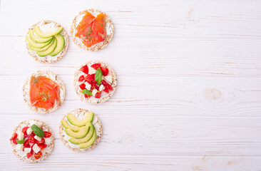 Rice cake with  salmon avocado mozzarella  and tomatoes