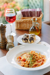 Spaghetti pasta with tomatoes and shrimps in a restaurant of italian food