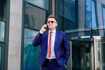 A man business man talking on the phone on the street