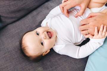 Baby Girl Laughing While Being Tickled My Mother - obrazy, fototapety, plakaty